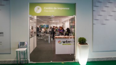 A man looking on the WTM London brochures