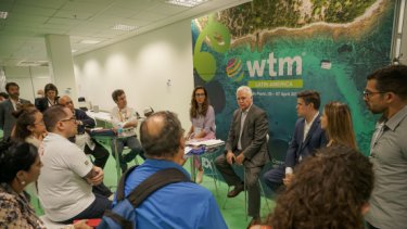 A man looking on the WTM London brochures