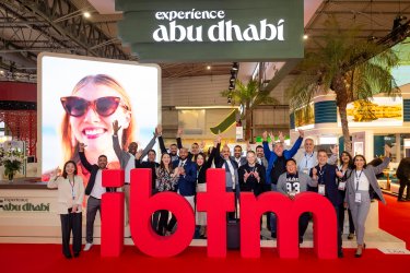 A smiling girl with sunglasses in a poster at ibtm