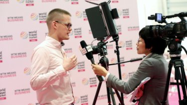 A man interviewed by a media woman at WTM London Interview Wall